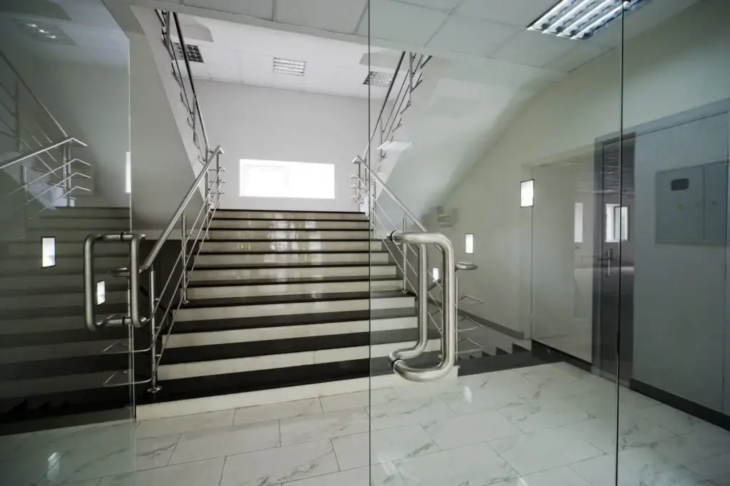 All glass entrance doors and sidelites at a building stairwell lobby