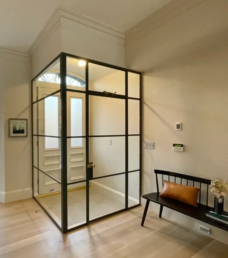 Black grid glass vestibule enclosure at a home entry