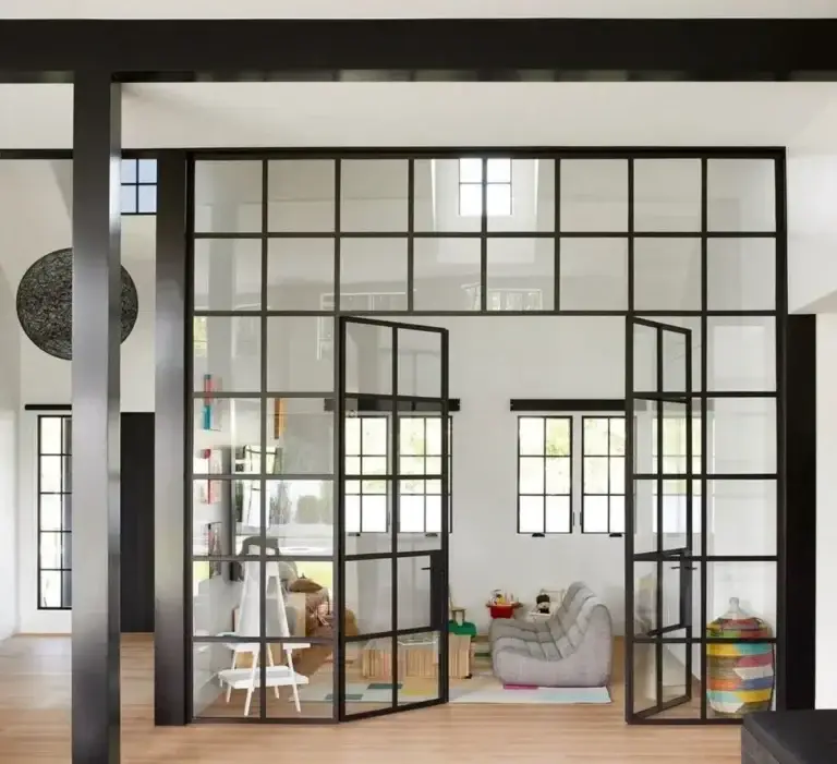 Black grid glass wall with double doors enclosing a playroom
