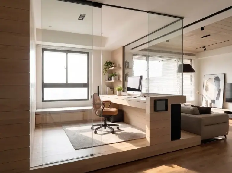 Frameless glass wall around a raised home office platform with a built-in desk