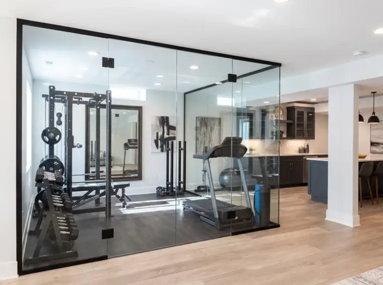 Glass walls and double doors enclosing a home gym