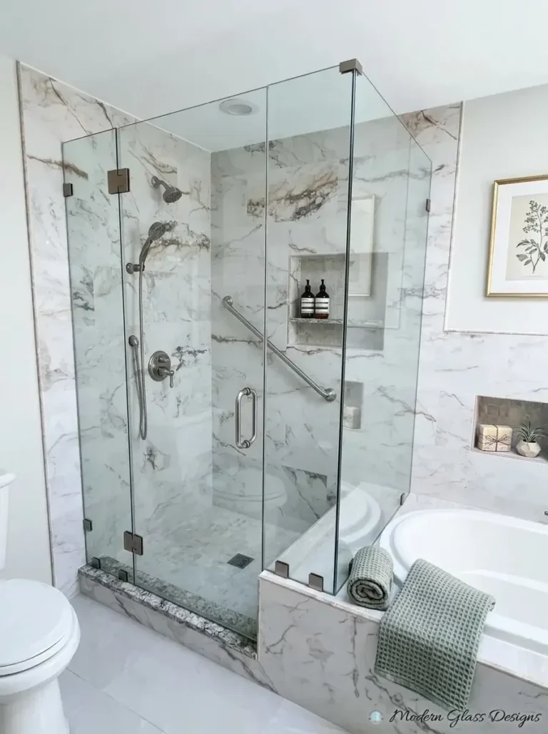 Frameless corner shower beside a tub with brushed nickel hardware