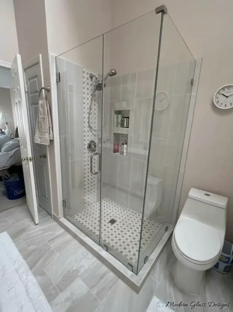 Frameless corner shower with a black corner clamp and chrome handle