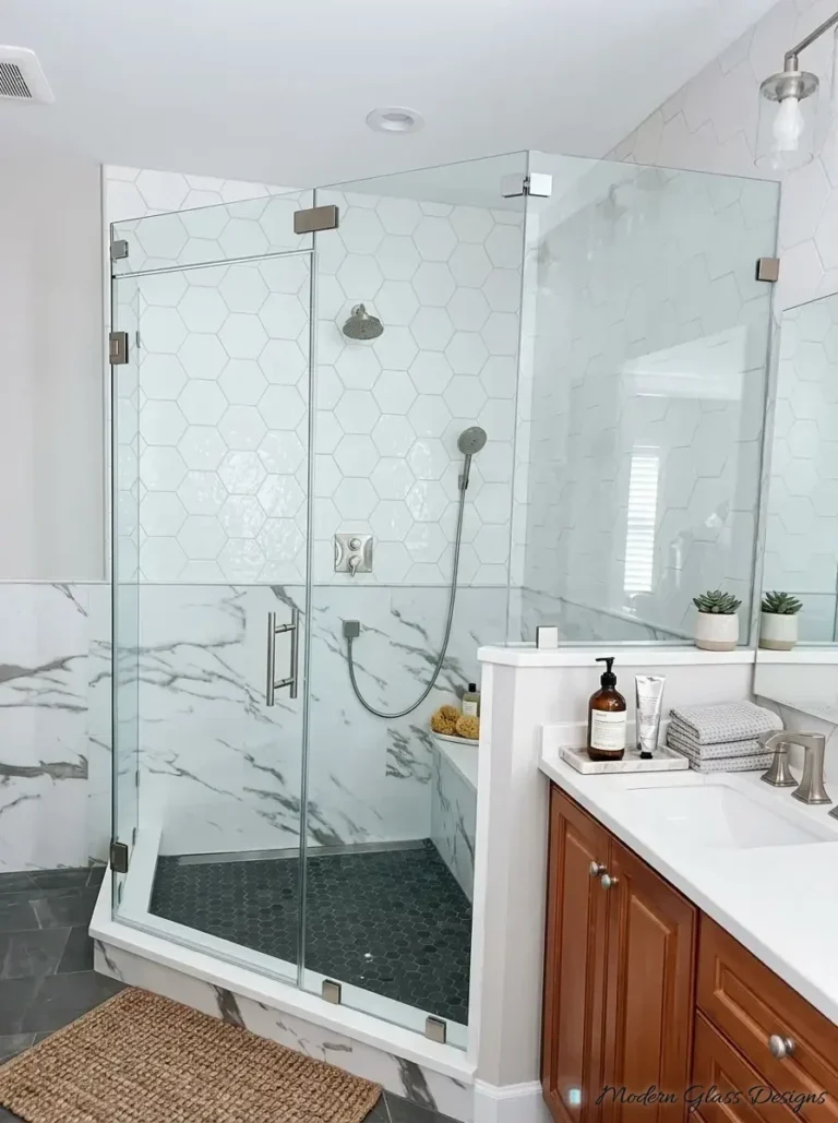 Frameless corner shower enclosure with brushed nickel hinges