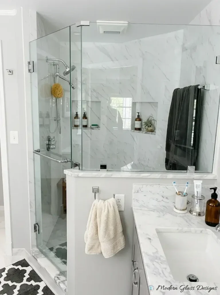 Frameless shower door and knee wall panel with a through-glass towel bar