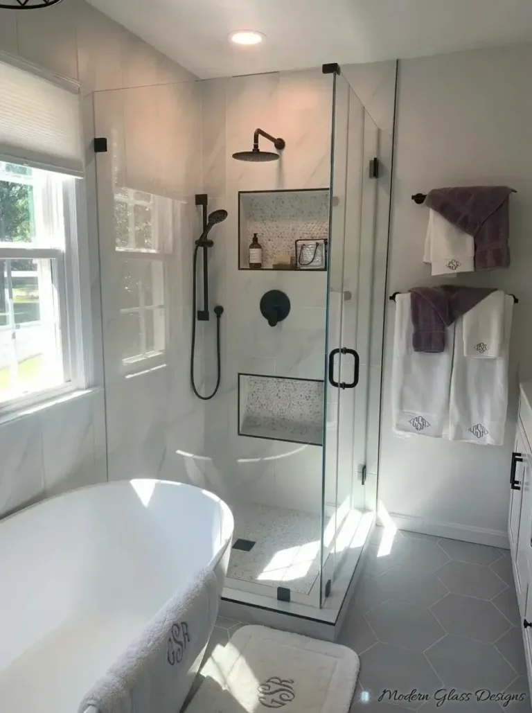 Frameless corner shower with matte black hardware beside a freestanding tub