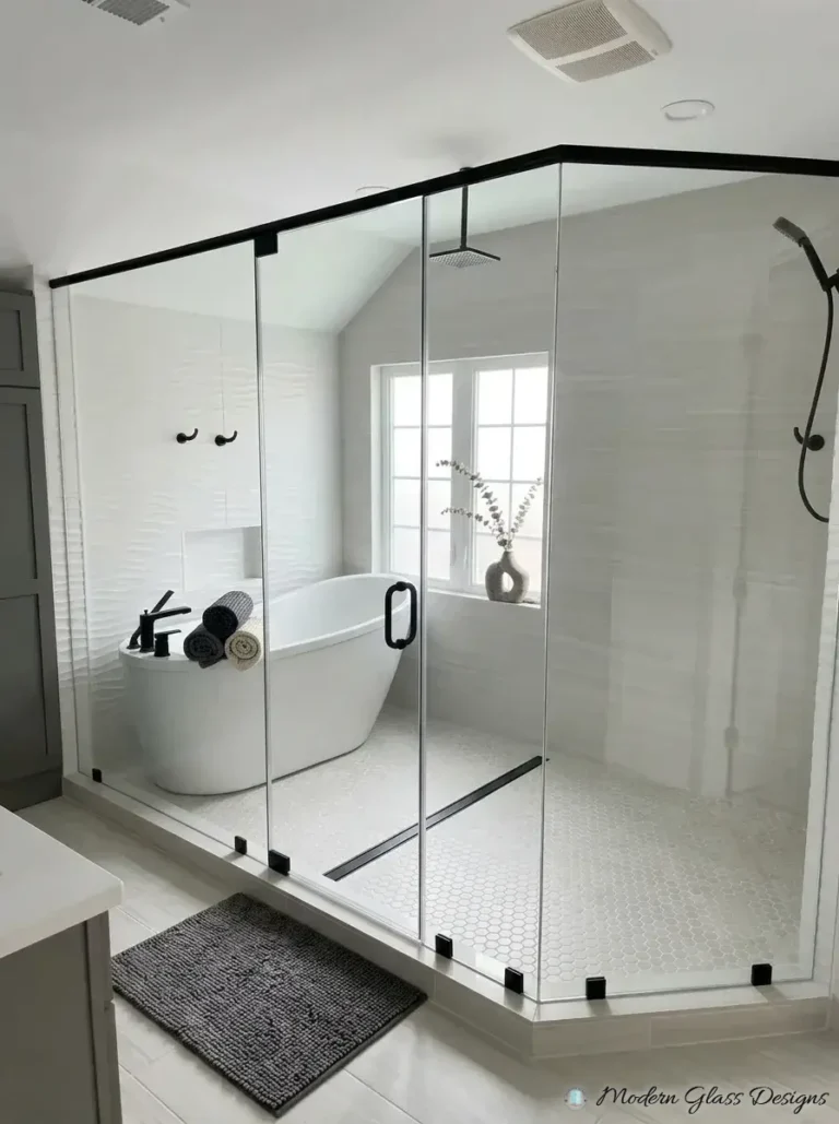 Corner glass shower enclosure with matte black header bar and door