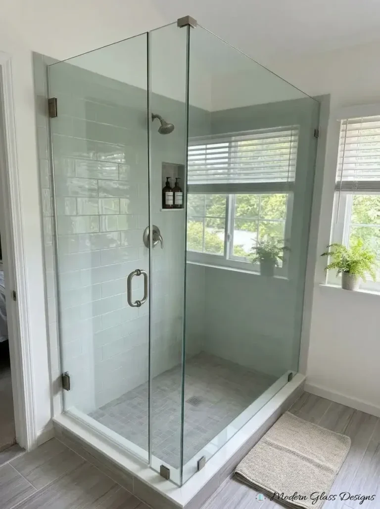 Frameless corner shower with brushed nickel hinges and corner clamps
