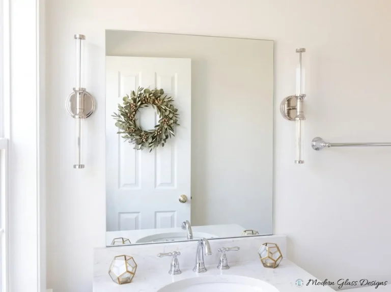 Frameless vanity mirror between two wall sconces