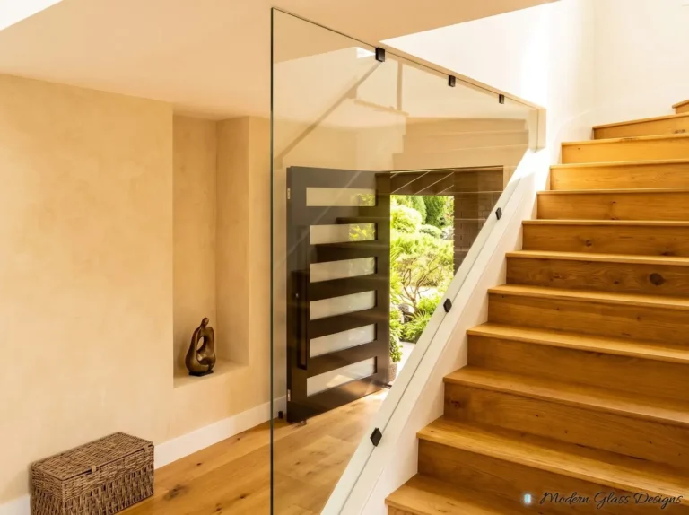 Full-height glass panel along an oak staircase in a front hall
