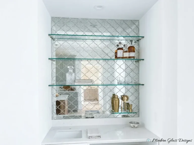 Glass shelves in a bar niche with arabesque tile