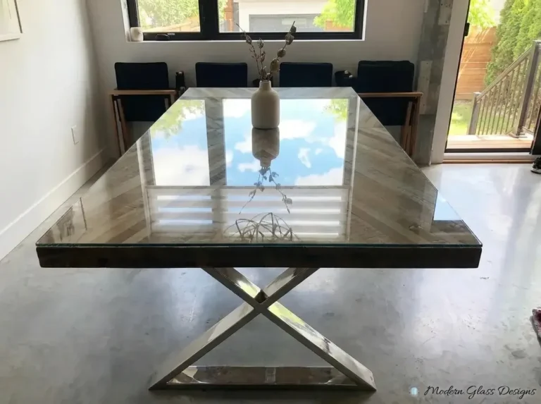 Glass table top on an X-shaped metal base