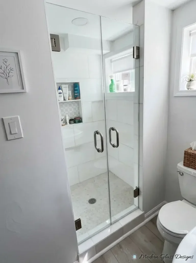 Frameless double shower doors with brushed nickel pulls