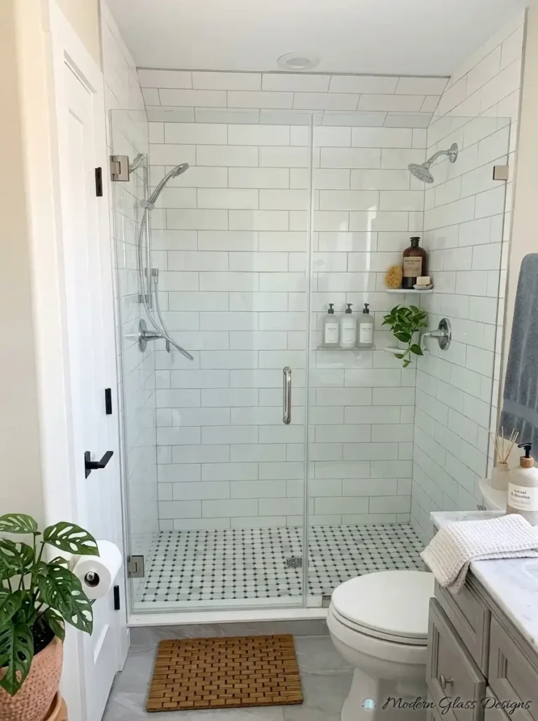 Frameless inline shower door and fixed panel with brushed nickel hinges