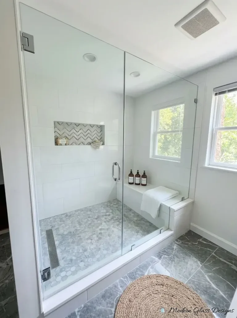 Frameless inline shower door and panel under a sloped ceiling