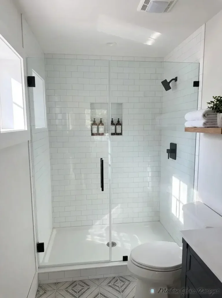 Inline frameless shower door and panel with matte black clamps and pull