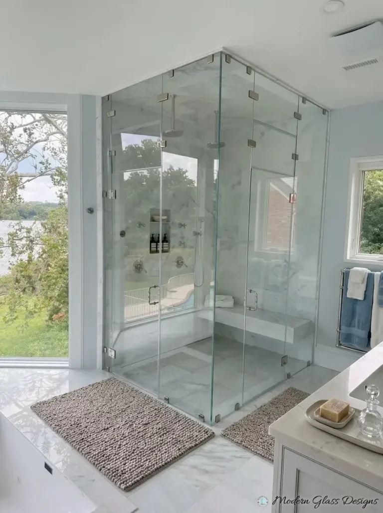 Corner steam shower enclosure with brushed nickel clamps to the ceiling