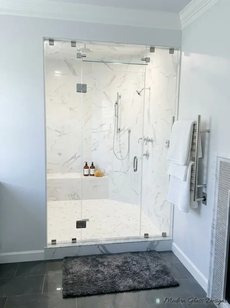 Steam shower front with glass transom and brushed nickel hardware